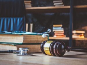 A wooden gavel, medical books, and a stethoscope on a lawyer's desk, symbolizing the legal complexities of medical malpractice vs. medical negligence cases. Understanding the difference is crucial when pursuing justice for medical errors. A wooden gavel, medical books, and a stethoscope on a lawyer's desk, symbolizing the legal complexities of medical malpractice vs. medical negligence cases. Understanding the difference is crucial when pursuing justice for medical errors.